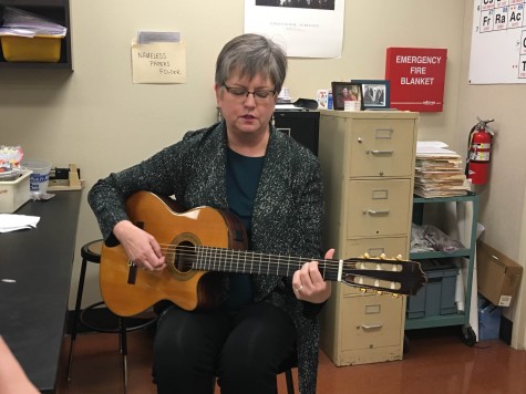 Science teacher Sally Hutsell performs a song