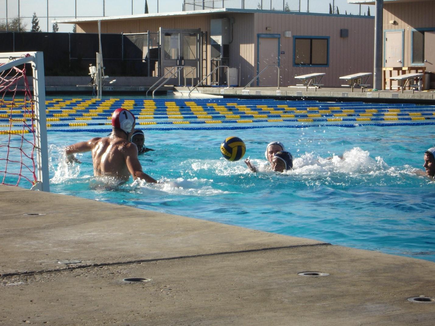 Tracy High junior, Cole Mannina, prepared to block a shot at the varsity water polo game at West High, October 6, 2016.