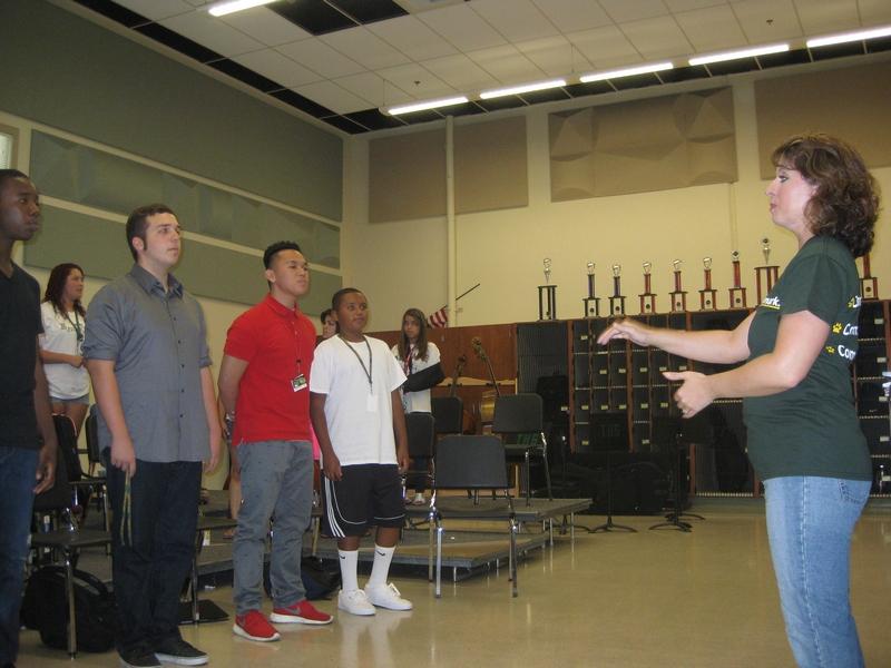 New choir teacher Jennifer Grover directs her Madrigals students.