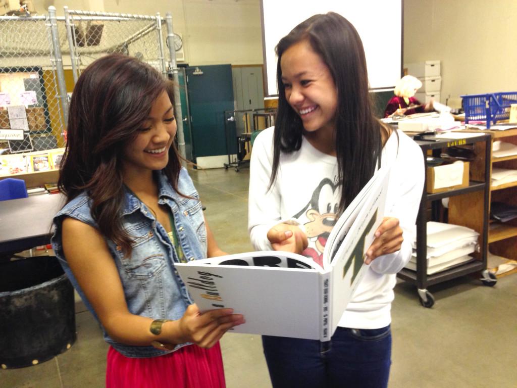 Maxine Almendra and Ellie Fisher look through last years yearbook.