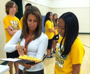 Paulette Keeney shows student their grade