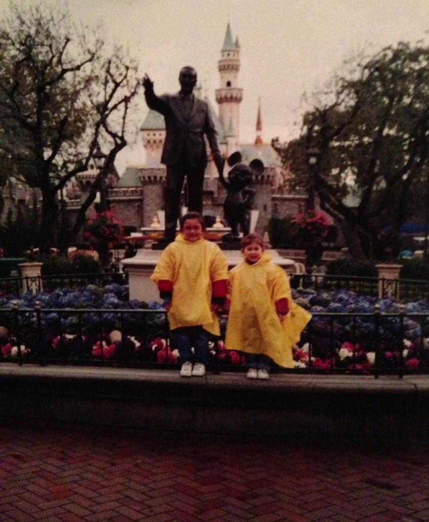 A childhood photo of Hunter Lew (R) and her sister as they stand near a statue at the Disneyland Resort in Anaheim, California.