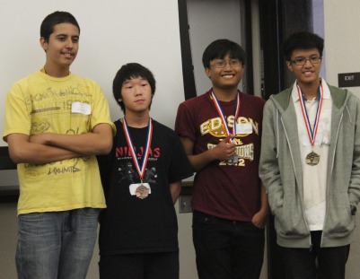 Junior Miguel Tauruc (far right) displays his gold medal for placing first in the math competition.