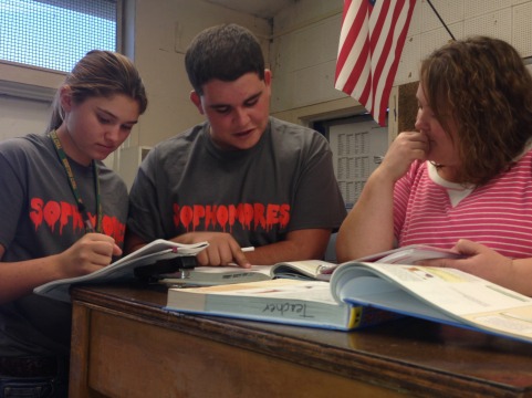Mrs. Maddux helps Hunter Andrade, sophomore, and Matthew Bongiovanni, sophomore, with homework