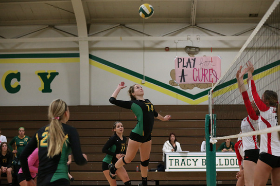 Senior Sammy Gonzalez jumps to spike the ball against Lincoln.
