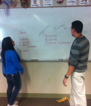 Spanish teacher, Jaime Perez, helps student Jessica Tober, Junior study for a test.