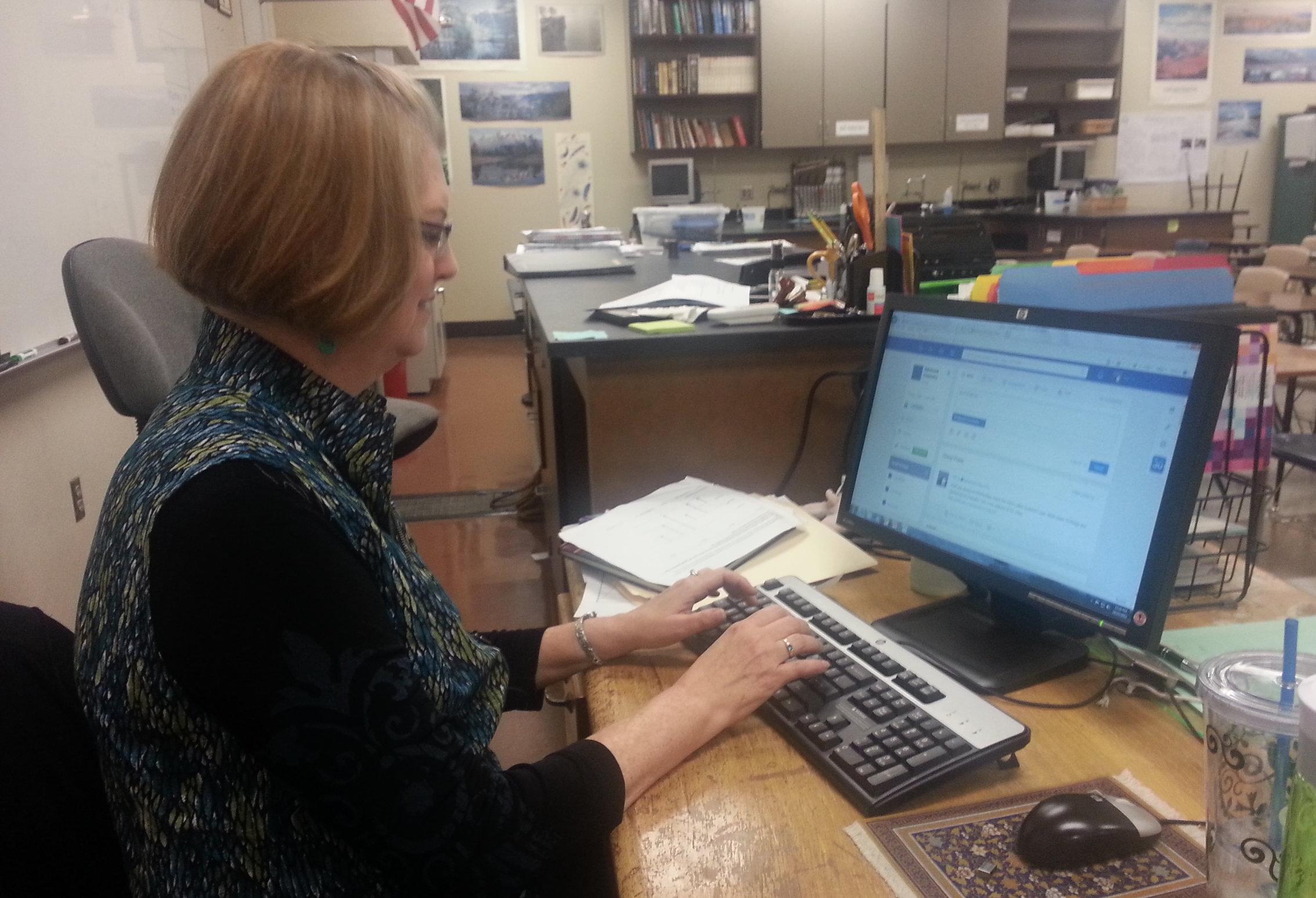 Sally Hutsell updates a homework assignment for her Advanced Chemistry class on Edmodo.