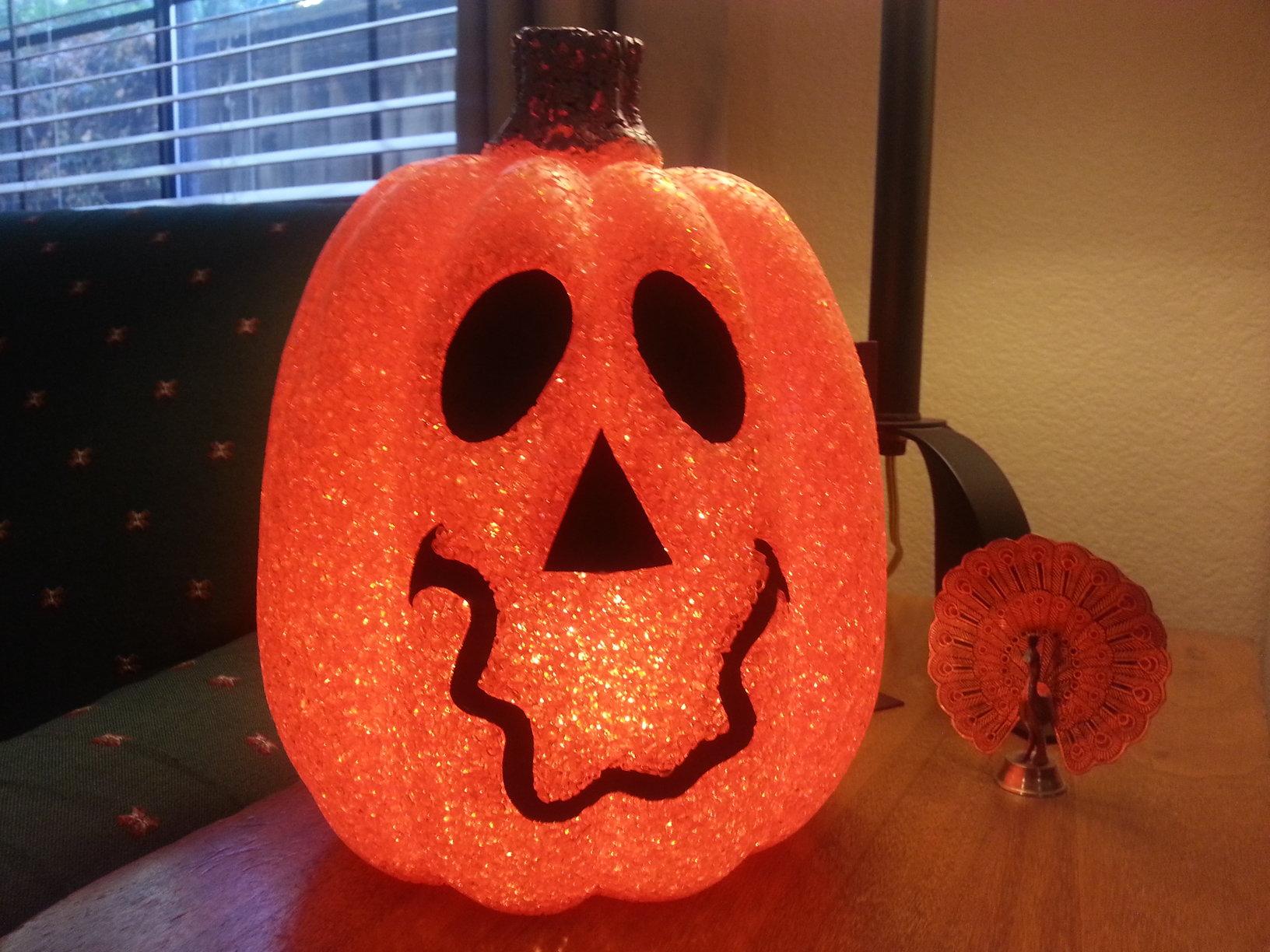 A pumpkin lantern serves as a Halloween decoration.