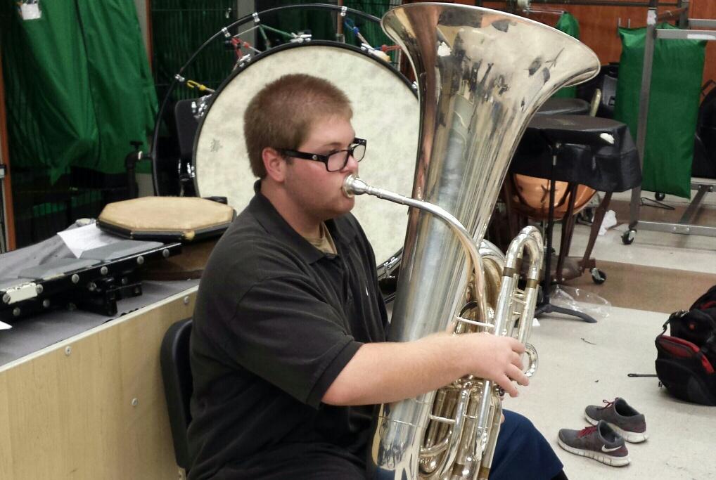 David Just practices playing the tuba for the county honor band performance.