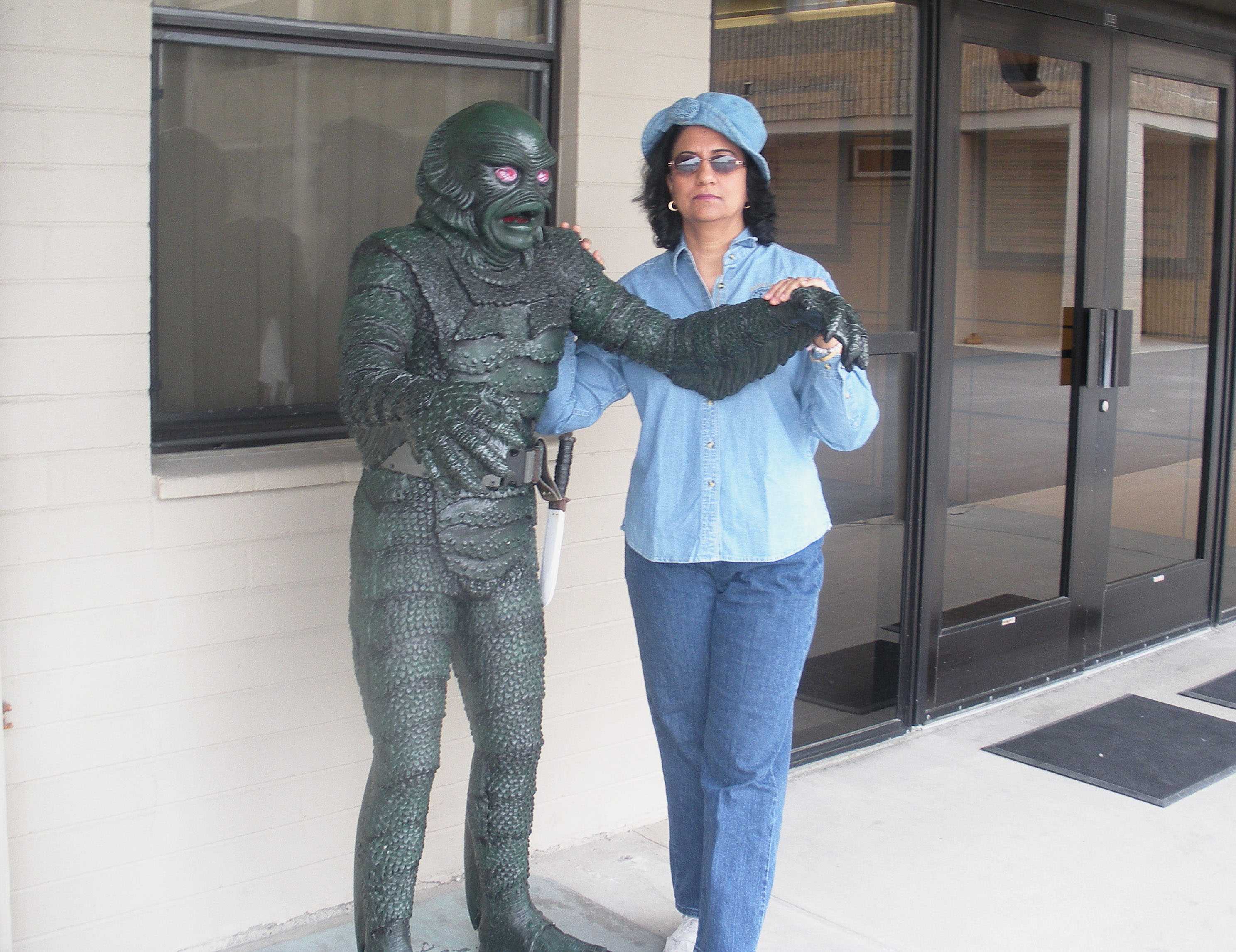 Rashmi Ahuja poses with a statue during one of her many trips.