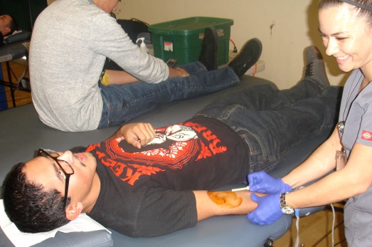 Junior Brandon Medrano donates blood for the first time. 