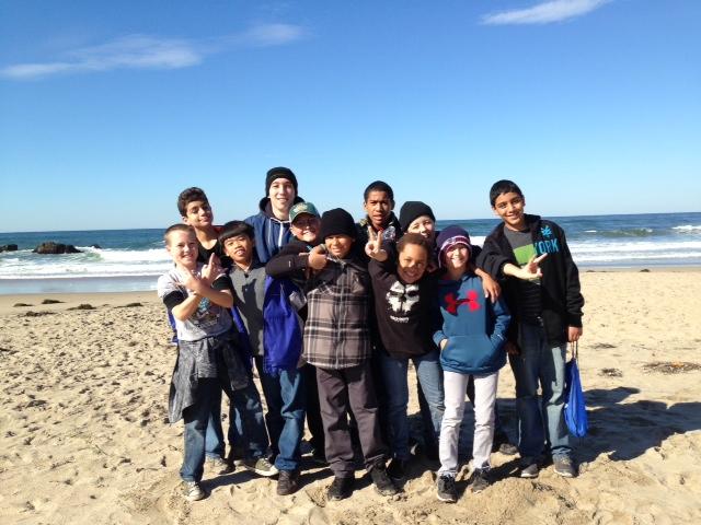 Junior John Sullivan with campers at the beach.