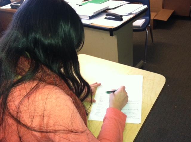 Senior Brenda Lopez does her history review sheet for finals.