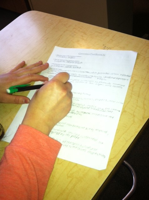 Student answers questions on the final review sheet