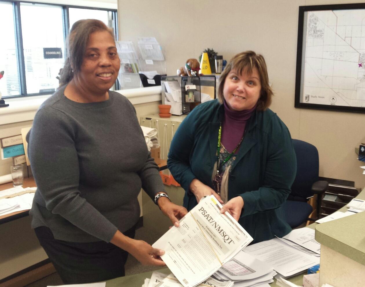 Counselor Gloria Miller and secretary Merry Zimmerman organize testing reports.