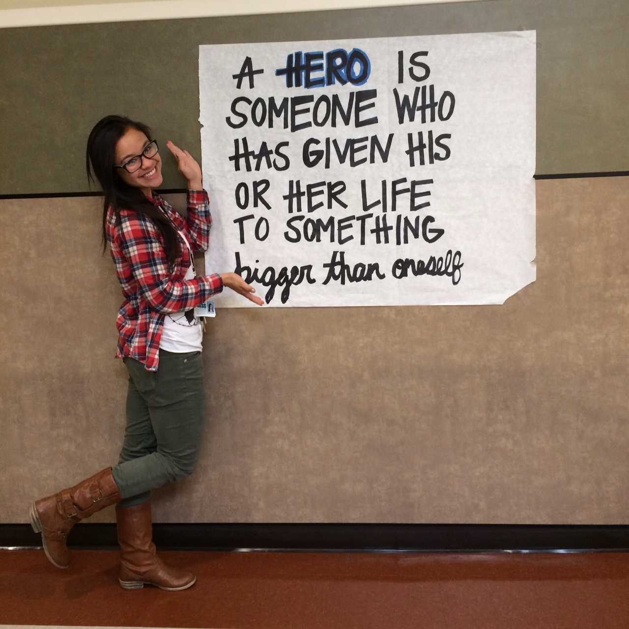 Ellie Fisher poses with one of the Hero posters in the A building. 