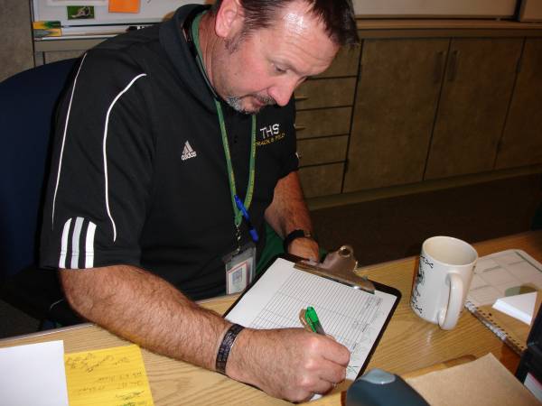 History teacher Jay Fishburn writing down the lesson plan for the day.