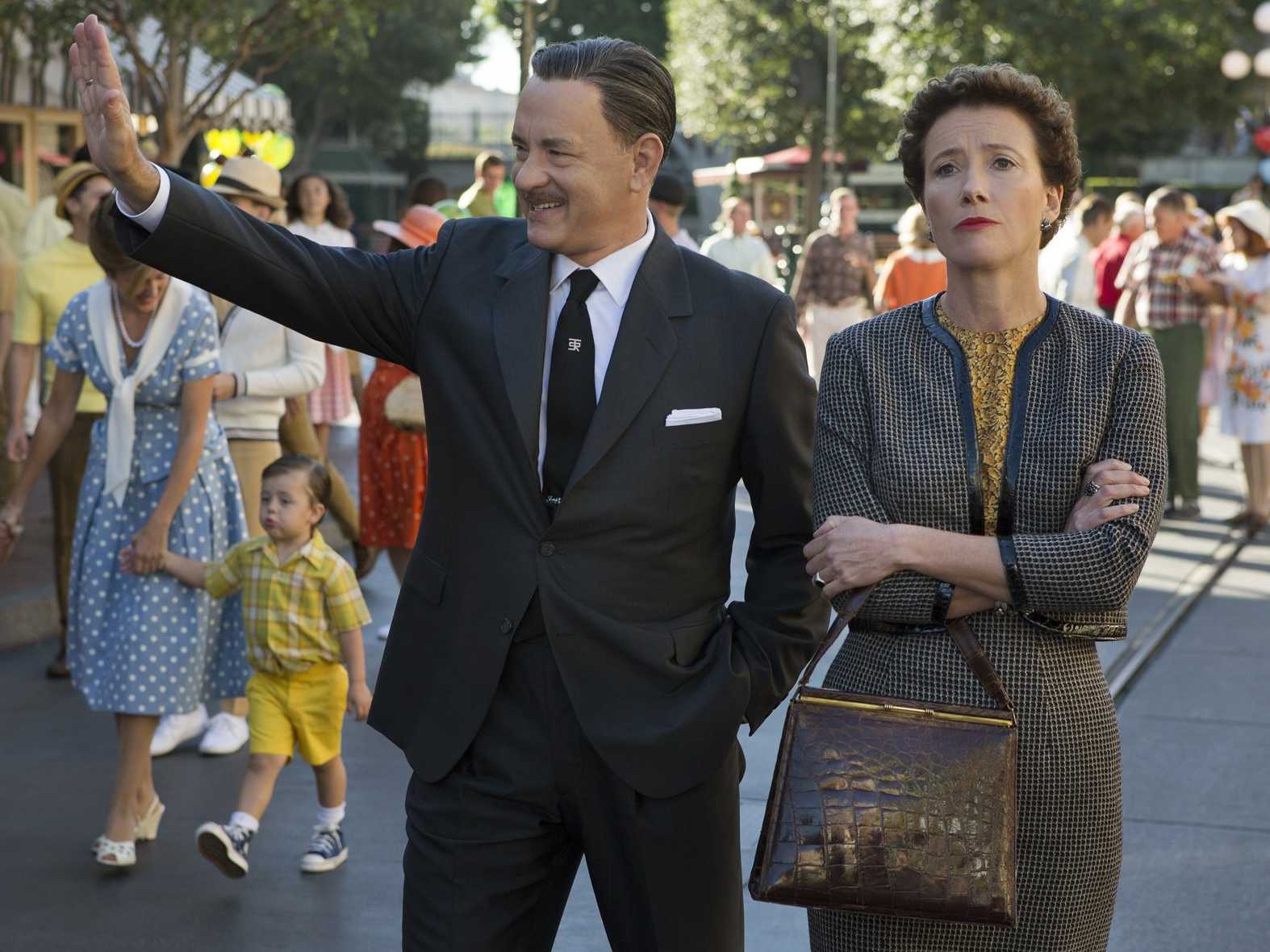 Walt Disney (Tom Hanks) walks around Disneyland with Mary Poppins author P.L. Travers (Emma Thompson).
