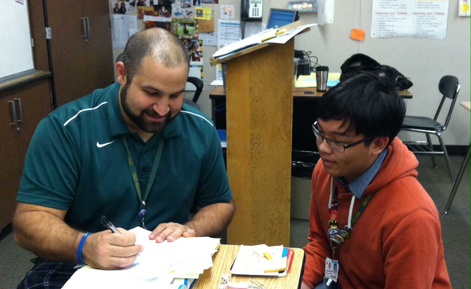Ryan Hern teaches a student how to do a math problem. 