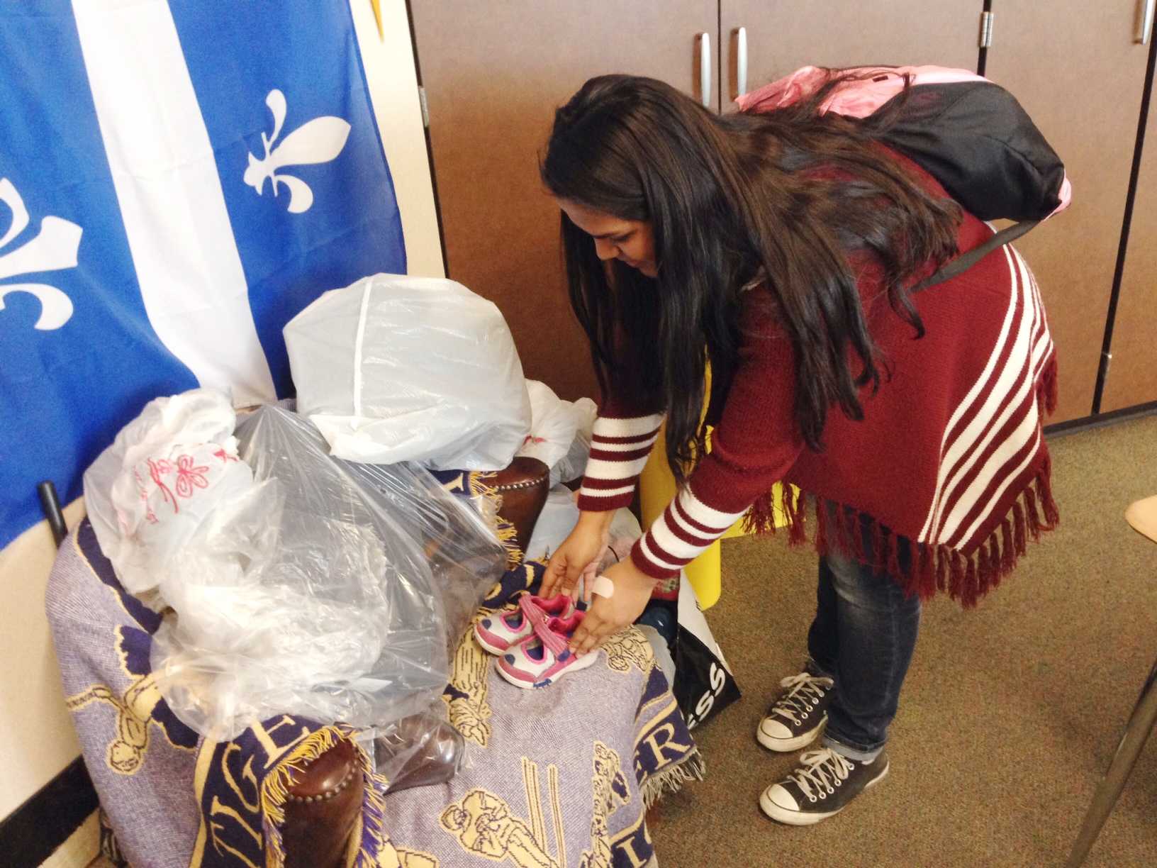
















Tania Torres, a student at Tracy High donates a pair of shoes for the school shoe drive.





