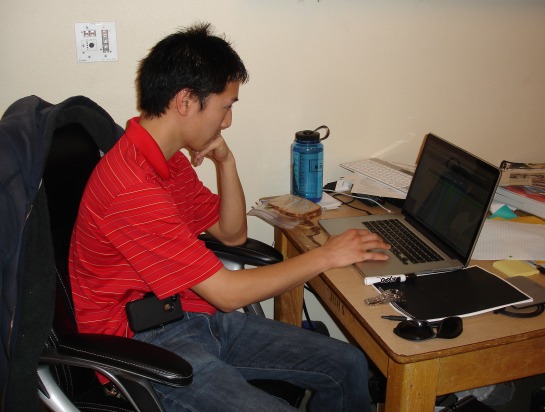 Band Director Jeffrey Kumagai working at his computer