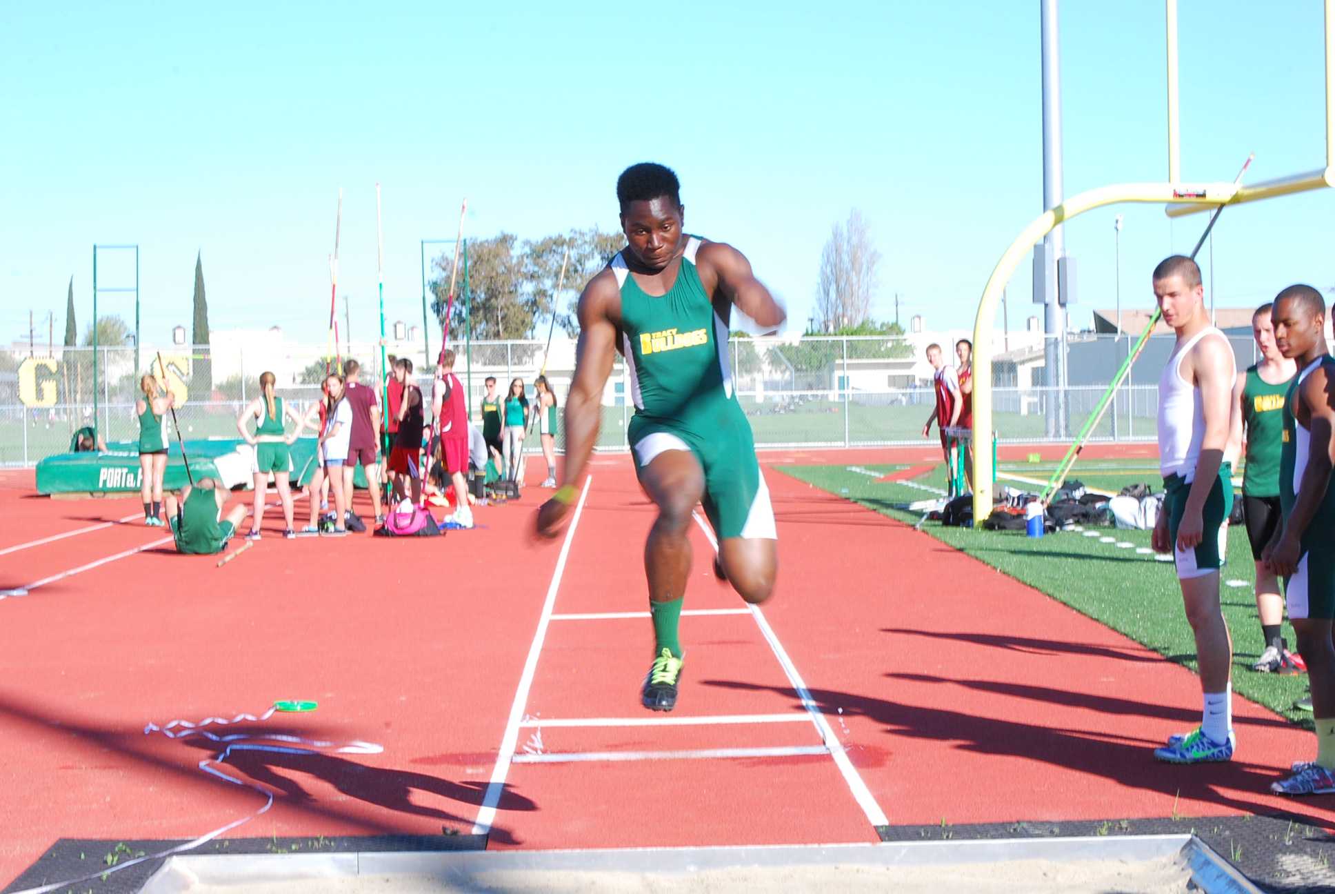 Senior George Obinna takes off for a jump in a long jump event against Liberty High School at Tracy High School on March 13.