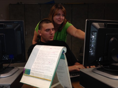 Mrs. Avila helping senior Alexander Warner with his research.