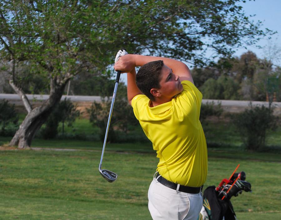 Sophomore Gavin Bean finishes his swing during the match. 