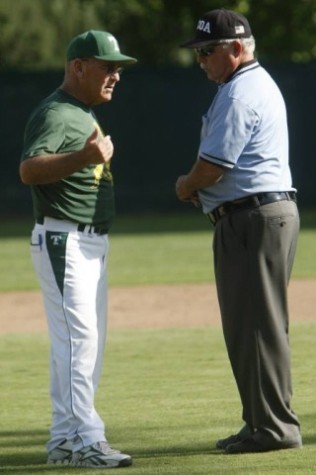 Head coach Vic Alkire talks to the umpire.