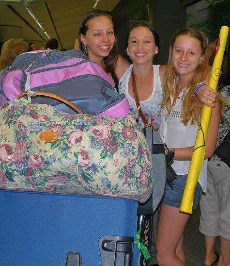 Welcoming my sister Ashlee (L) home from her year abroad with my other sister LeeAnn (M), at the end of junior year.