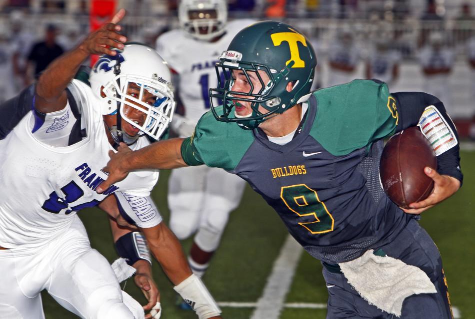 Damon Stroup carries the ball against Franklin of Elk Grove.