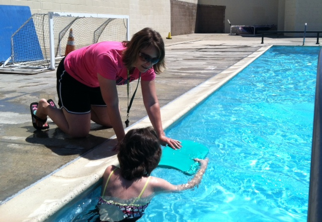 Amanda Bowman helps a student out during the swimming unit