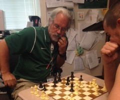 Math teacher Greg Smith challenges a student to a game of chess.