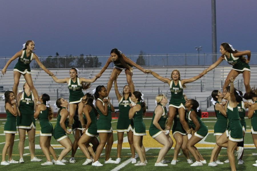 Tracy High cheer team performs at halftime during the Lions All-star football game in June.