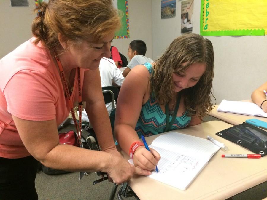 Math+teacher+Kathy+Teixeira+helps+freshman+Megan+Bernard++with+classwork.