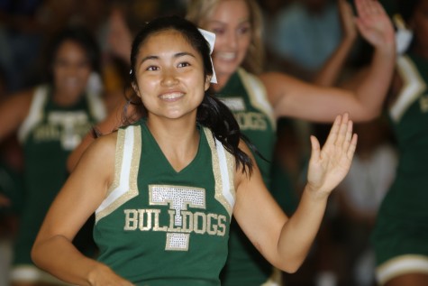 Cheerleader Mikaela Mizuno smiles for the camera during the cheer routine.