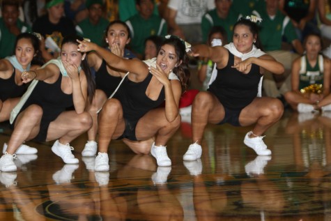 Dance team strike a pose during the superhero-themed routine.