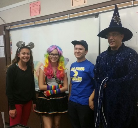 Students pose with their teacher in their costumes