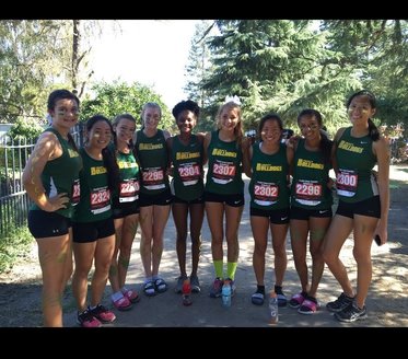 Varsity cross country girls pose for a picture before their race at the University of the Pacific Invite. 