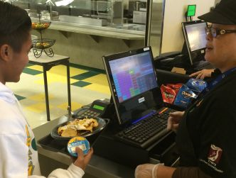 Philip Garcia purchases school lunch inside the school cafeteria.