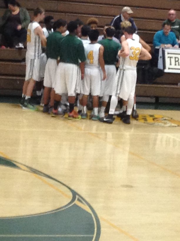 Varsity boys basketball huddles up during a time out on Dec 14. against Central Valley