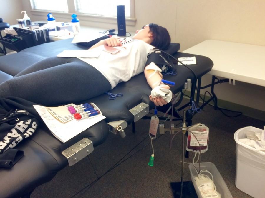 Junior Julia Cross donates a pint of blood at the blood drive on Dec. 9.