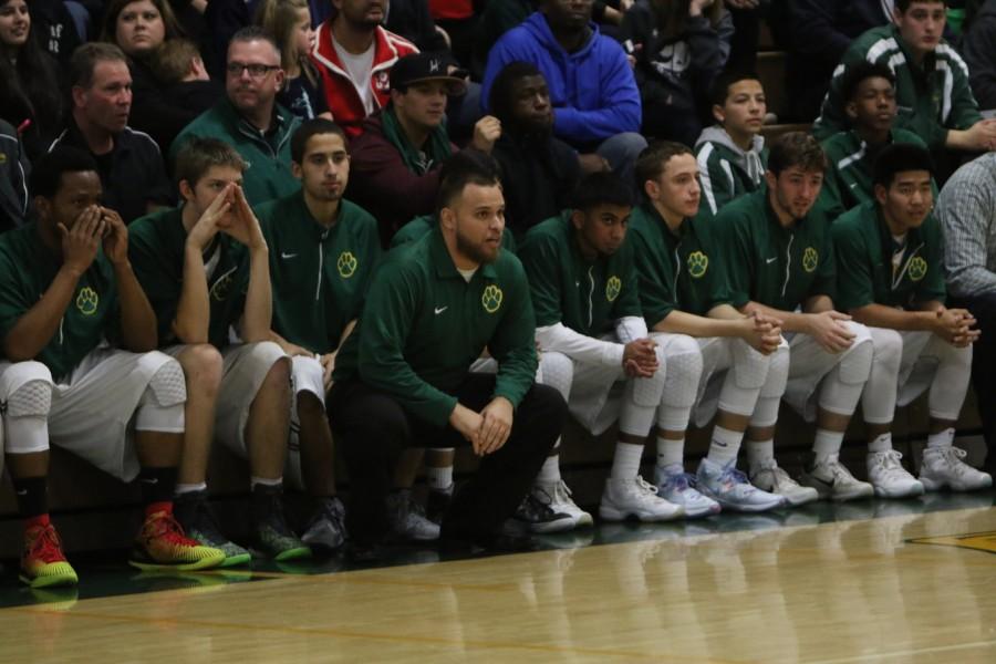Head coach Junior Cueva and the bench looking at the game at hand