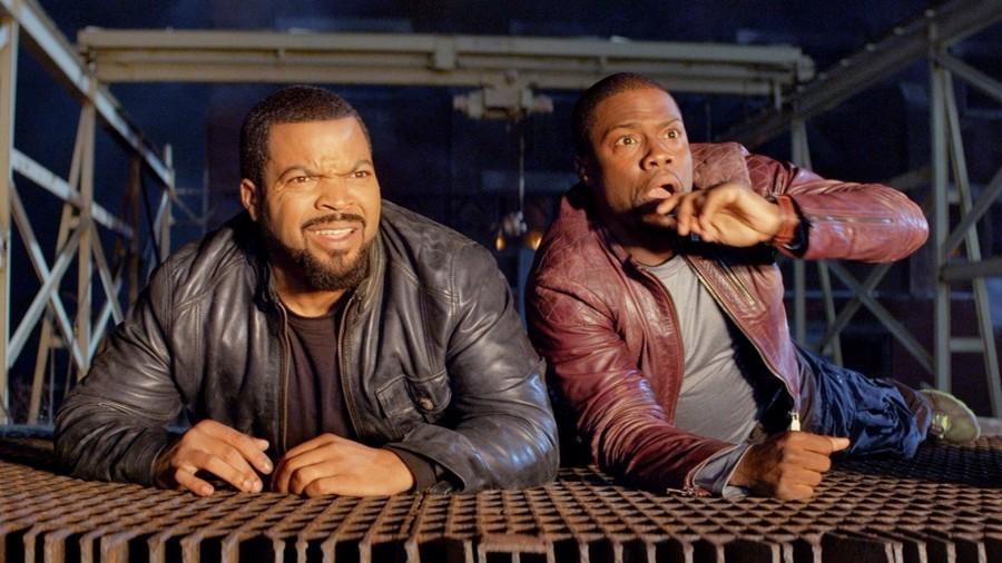 Ice Cube (left) and Kevin Hart (right) watch an explosion in The Ride Along 2. 