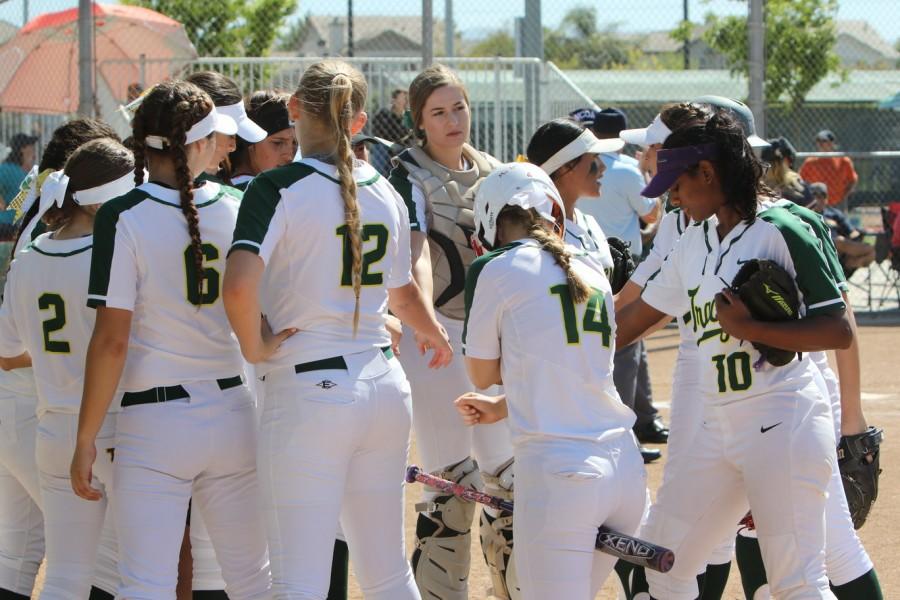 Tracy High softball team getting a team break before the inning starts.