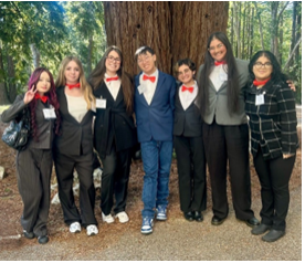 The team poses in their matching red bowties, a yearly tradition. 
